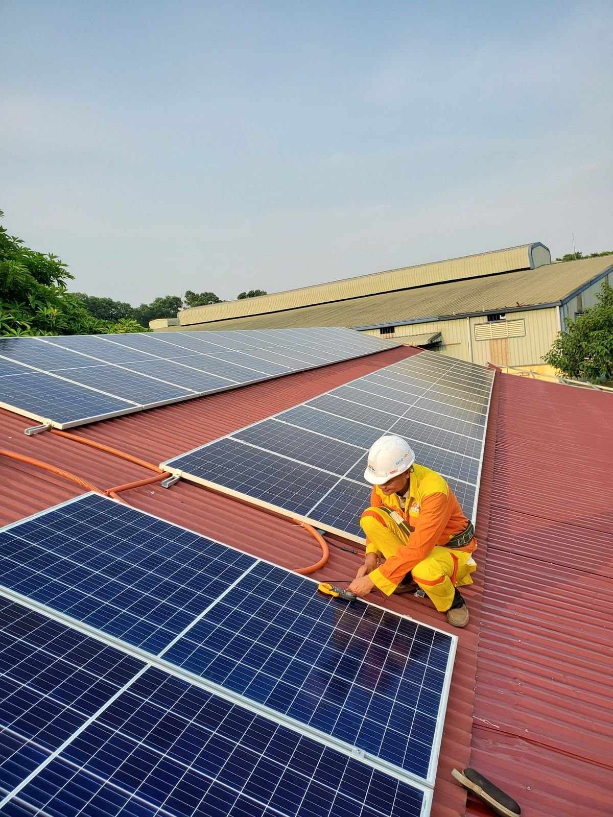 Technician installing rooftop solar panels under the subsidy scheme